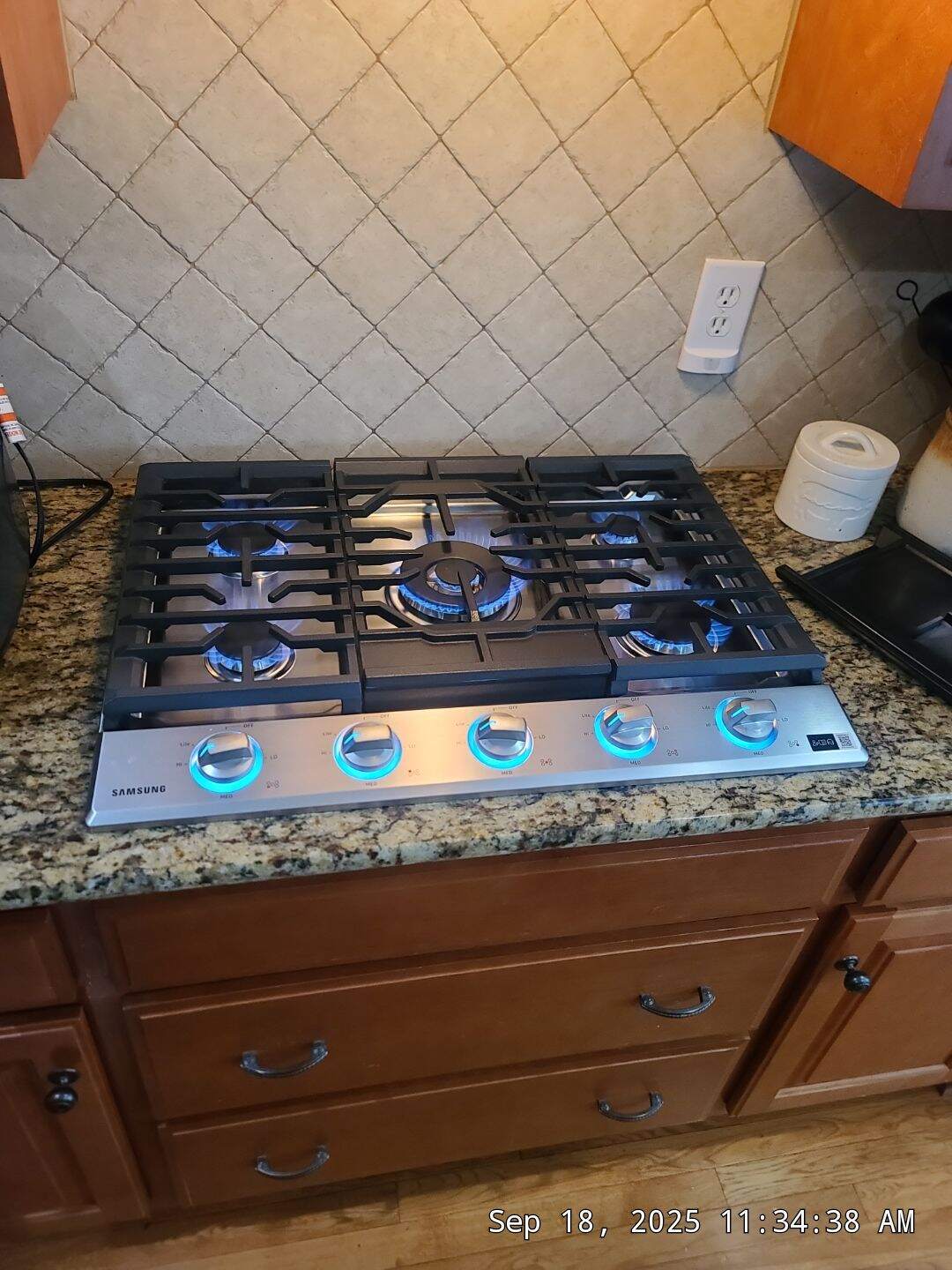 Gas cooktop installation with blue flames in Huntsville kitchen remodel